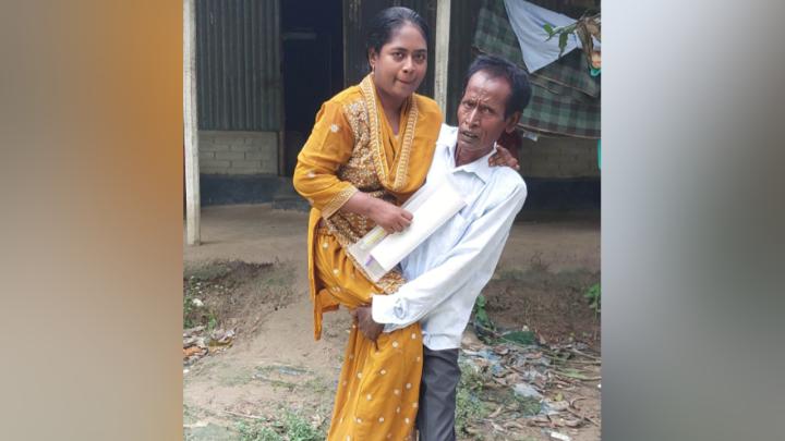 বাবার কোলে চড়ে যাতায়াত করেন প্রতিবন্ধী হাসি। ছবি: সংগৃহীত